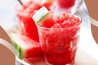 Watermelon Shrub icy drink in a glass with a watermelon slice and silver spoon