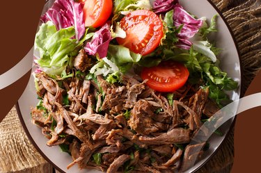 Healthy Instant Pot Carnitas with lettuce and tomato on a white plate on wooden table