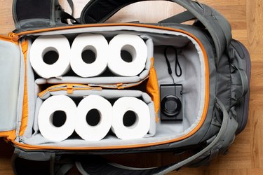 rolls of toilet paper packed in a suitcase, to represent travelers diarrhea