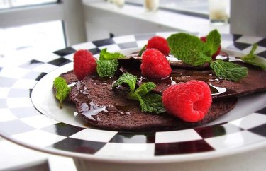 Flourless Chocolate Mint Pancakes on plate with raspberries