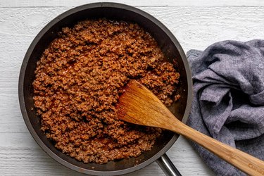 Season beef with spices; cook until sauce thickens.