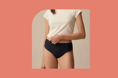 black everlane invisible high-rise hipster underwear on a beige and coral background