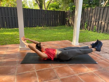 Woman doing a hollow body hold as a push-up alternative
