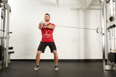 Man doing Palloff press with a cable machine at the gym