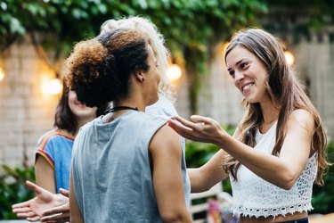 Two Young Women Greeting Each Other During Barbecue Meetup