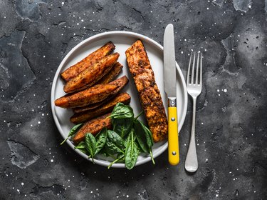 plate of baked salmon with sweet potato and spinach, as an example of stress-relieving foods