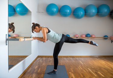 Person practicing a beginner barre workout to improve strength and posture.