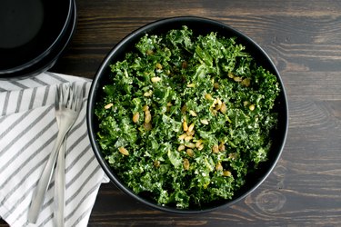 top view of a bowl of kale salad, as an example of foods with vitamin K