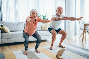 Couple exercising together at home.