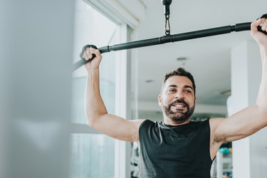 bearded man pulling weitght at exercise machine