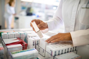 Pharmacist organizing the medicine drawer