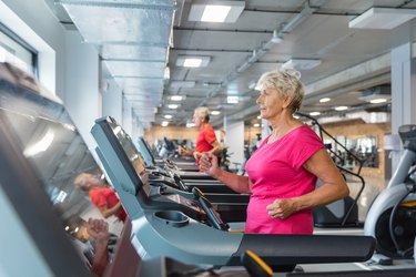 Older adult walking on treadmill in a gym as example of best exercise equipment for people with osteoporosis