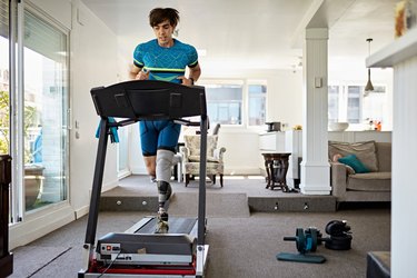 Man running after applying treadmill belt lubricant.