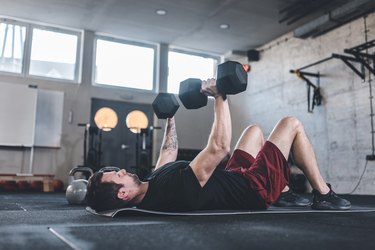 Caucasian man doing exercises for the chest using dumbbels