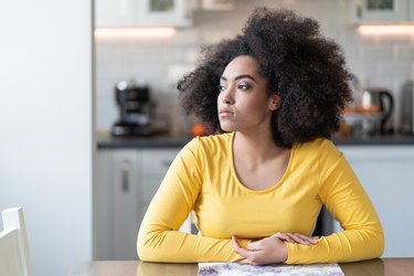 Depressed afro woman at home