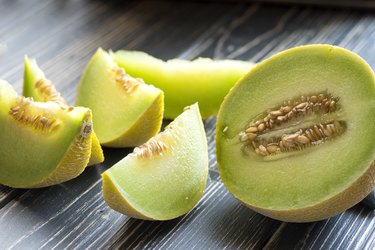 Fresh L-citrulline-rich honeydew melon on wooden table