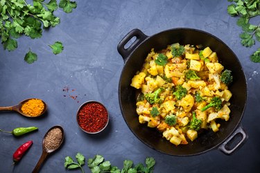 Aloo Gobi Indian Dish in a Large Cast Iron Pot With Turmeric, a potent healthy-aging spice