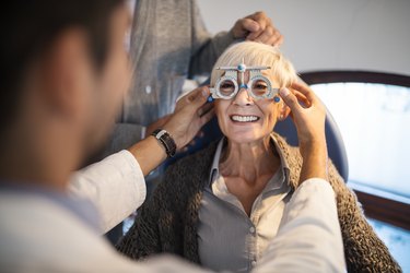 older woman getting an eye exam, as a method of fall prevention