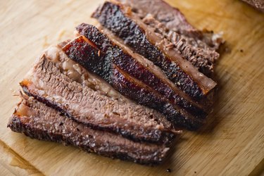 Sliced brisket slow cooker style on a wooden cutting board