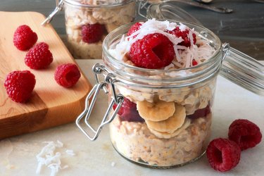 Breakfast overnight oats with fresh raspberries in a  jar