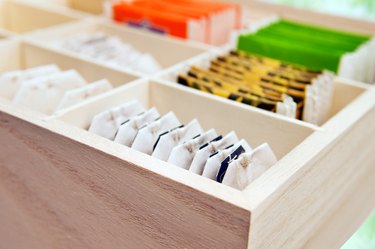 different brands of tea bags in a wooden box