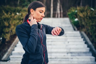 Jogger checking pulse on neck