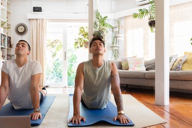 two people doing yoga in their home to demonstrate the best morning workouts