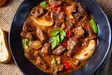 above shot of beef stew, flavored with Bovril in a bowl on a table.