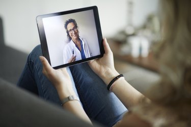 Young woman having online meeting with female healthcare provider, as a way to find period cramp relief