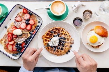 Personal perspective directly above view of man eating breakfast at a cafe