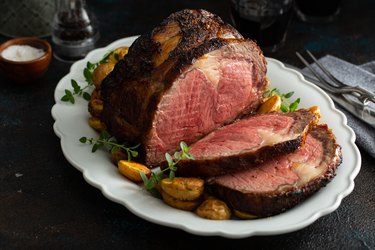 Semi-boneless beef roast on a serving platter sliced