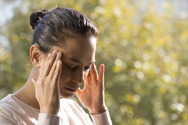 person with a headache in their temples