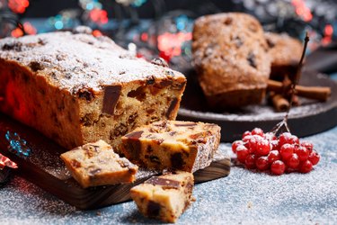 Traditional Christmas cake with rehydrated dried cranberries and fruits and nuts in festive decoration