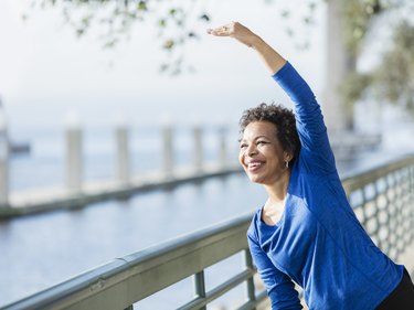Mature African-American woman exercising on waterfront