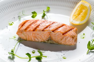 Grilled salmon fillet on white plate