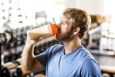 Man drinking protein shake at the gym