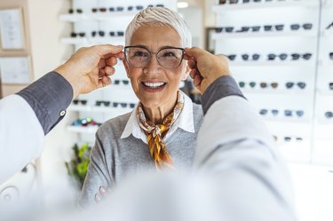 a senior woman being fitted for new glasses, to represent vision changes with age