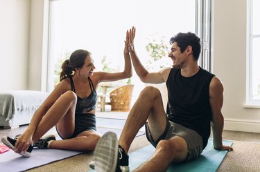 Couple high-fiving after a successful workout session