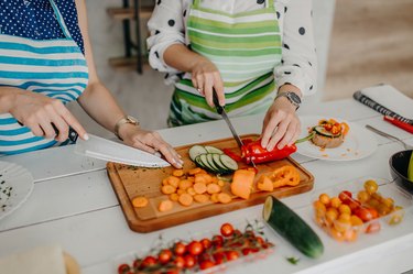 Young women preparing food in the kitchen