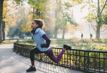 woman in the park performing Bulgarian split squats