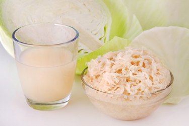 German Sauerkraut and Sauerkraut Juice with White Cabbage on tabletop