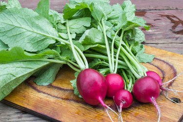 Fresh organic radishes on a chopping board