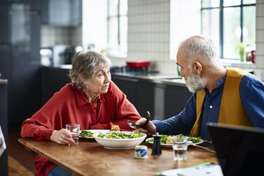 Older adults eating dinner together to help treat their loss of appetite as they age