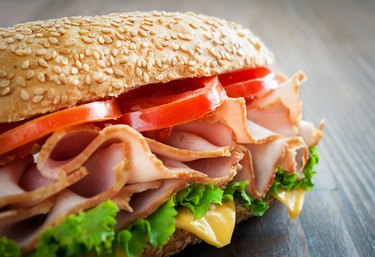 Close up of turkey sandwich on white bread, which has more calories than a turkey sandwich on whole wheat bread.