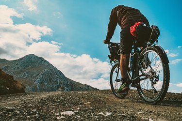 Person riding bicycle in the mountains wondering, 