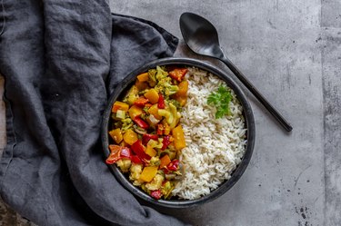 vegetarian pumpkin curry with rice on a slate table
