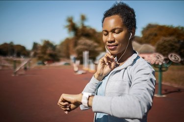 person wearing headphones and feeling ear pain during exercise