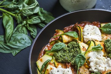 a close up photo of a Zucchini Skillet Lasagne with Basil leaves