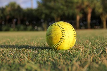 Close-up of a yellow softball on grass field