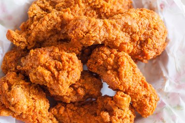 boiled fried chicken on a bed of paper towels on a plate.